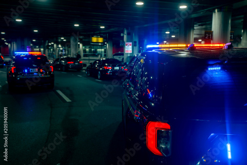 Obraz na plátně Police car patrol with flashing lights
