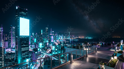 rooftop terrace and neon skyline with blank billboard copy space