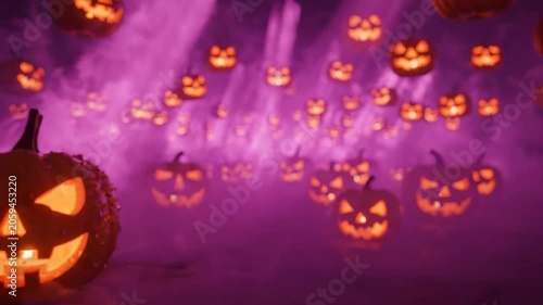 Halloween Pumpkins Glowing in Purple Light.