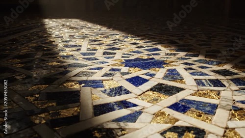 Mosaic tile floor with sunlight shining.