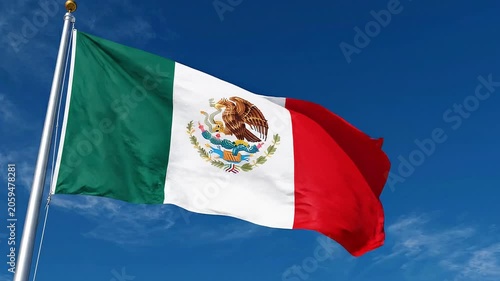 The national flag of mexico waving against a clear blue sky