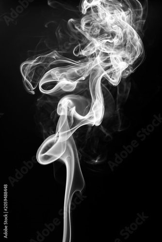 White smoke swirling and rising vertically on a solid black background.