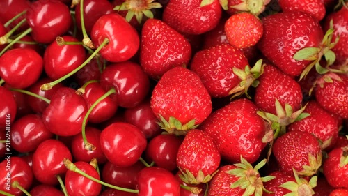Zoom frame heap of fresh cherry and strawberry close up, slider view