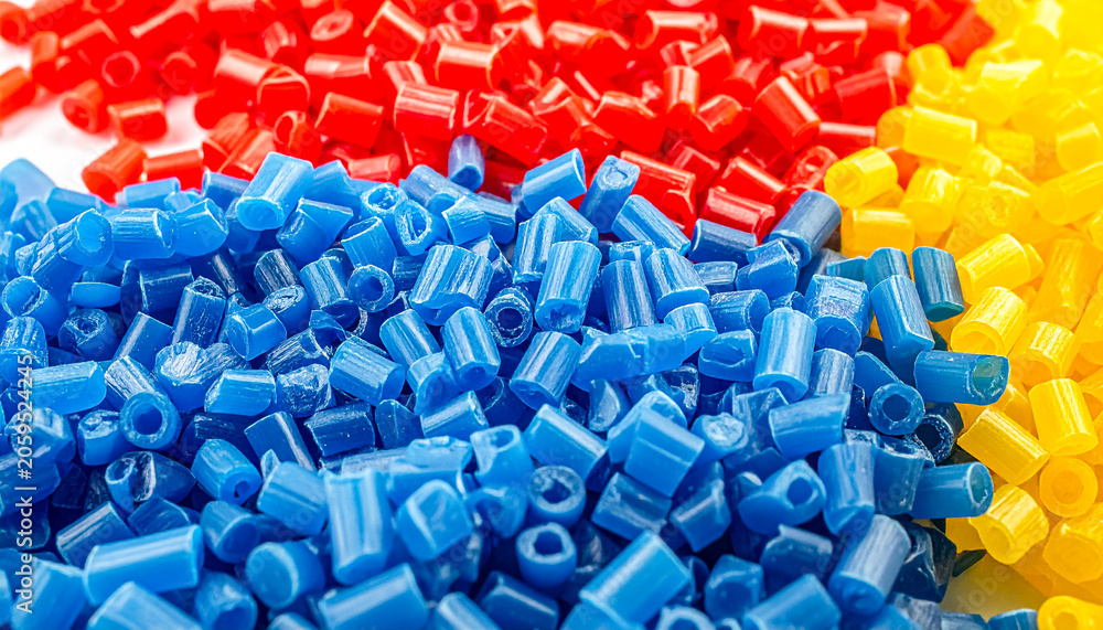 Obraz premium Colorful plastic beads in red, blue, and yellow for crafts.