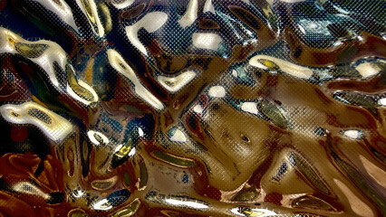 abstract liquid metallic texture with golden reflections and glossy chrome ripples creating an futuristic wavy background