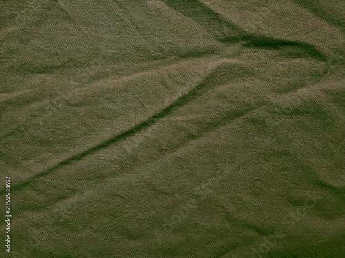 Fotografie olive green crumpled linen fabric texture background with organic folds and rust