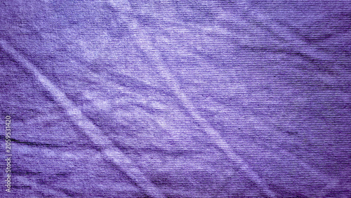 textured purple cotton fabric with natural creased folds and subtle ribbed lines creating an organic textile background