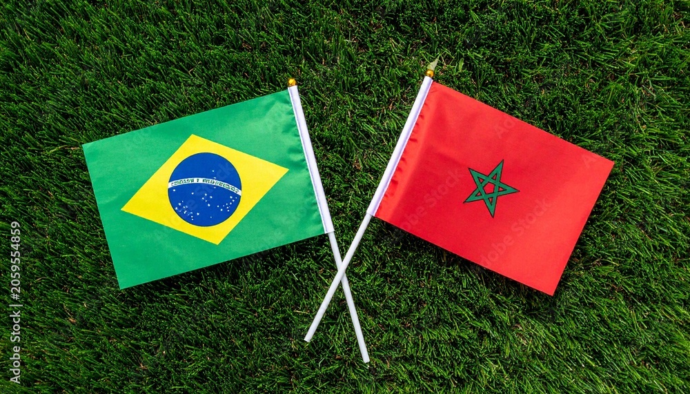 Fototapeta premium Brazil and Morocco flags side by side on grass, symbolizing unity, cultural pride, and international friendship in celebration.