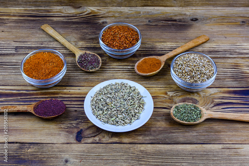 Spoons and bowls with oriental spices on a wooden table