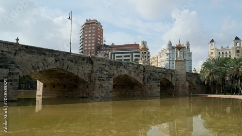 Ancient stone bridge in the city on the water beautiful clouds