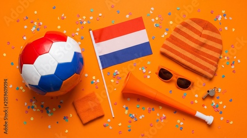 Dutch soccer fan items with confetti on orange background