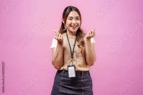 Fotografie Lovely young Asian woman in a brown shirt making a finger heart gestures