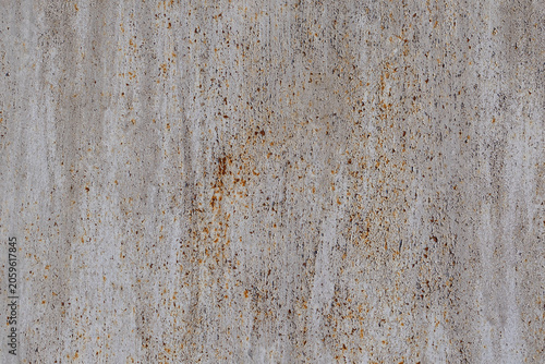 Rusty grey Metal Texture. Close-up texture of weathered grey painted metal surface with scattered brown rust spots and oxidation patterns.