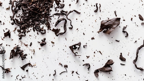 Dry black tea leaves scattered on white top down