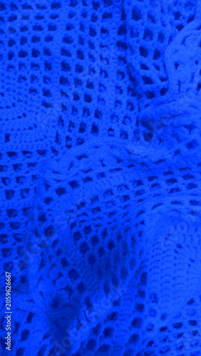 Luminous Blue crochet lace texture, handmade knitted cotton mesh pattern, vibrant electric blue network fabric