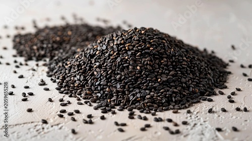 Black sesame seeds pile on light grey top down