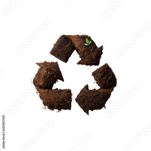 Recycle symbol made of soil and earth with a small green sprout isolated on white background