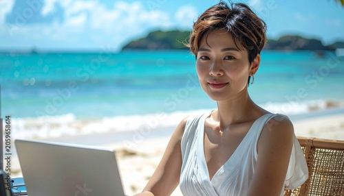 a professional brunette woman with short hair wearing a white summer dress sitting at the desk on the tropical beach on a sunny day, smart working photography
