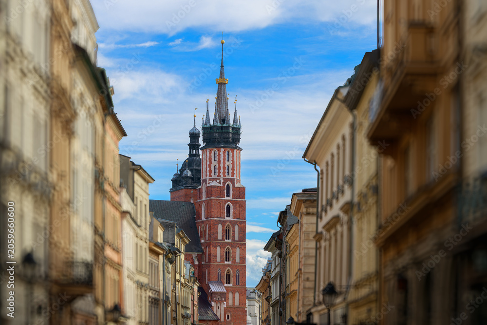 Obraz premium Krakow's historic town hall tower dominates a charming central alleyway
