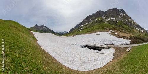 rest from avalanche, snow melting in the Alps of Vorarlberg make tunnel in the avalanche, snow on the mountains melts, snow from steep slope down in the valley