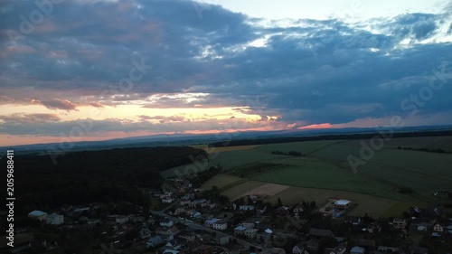 Aerial drone view of massive storm clouds moving across the landscape. The video captures dramatic weather patterns, shifting cloud formations, and the powerful atmosphere of an approaching storm from