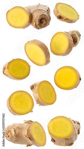 Sliced ginger on a white background arranged in rows