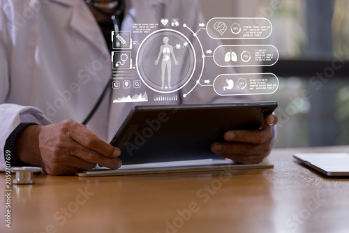 Doctor using a digital tablet to review patient records during a medical consultation in a healthcare clinic. Professional physician managing electronic health data diagnosis