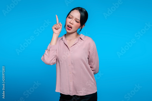Young Asian woman pointing up with a great idea