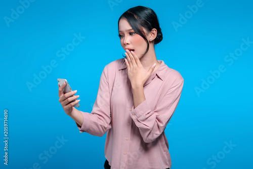 Shocked Asian Woman Looking at Smartphone and Covering Her Mouth