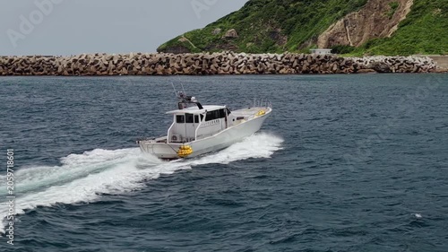 Aerial view of a vessel passing by Okinoshima Island
