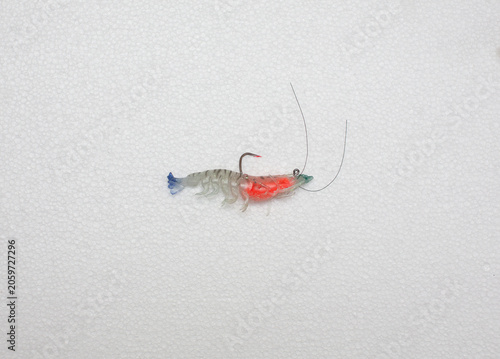 Artificial shrimp fishing lure, rubber, white background.