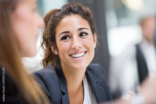 Charismatic business woman CEO smiling in open workspace, friendly manager, startup team, creative planning, vibrant professional energy