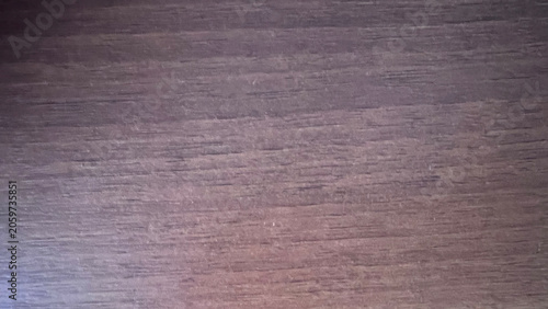 Bild auf Leinwand Close-up of a dark brown wooden surface with horizontal grain and subtle reddish undertones