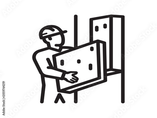 Man installing insulation panel in construction site