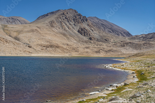 Mountain landscape view of colorful high altitude lake between Khargush pass and Pamir Highway, Murghab, Gorno-Badakhshan, Tajikistan