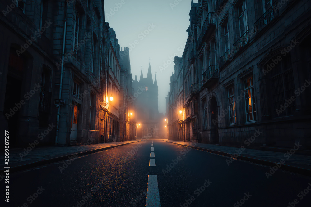 Fototapeta premium Empty European Old Town Street At Night With Glowing Lanterns And Misty Cathedral