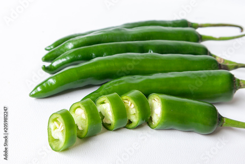фотографія Fresh green chili peppers isolated on white