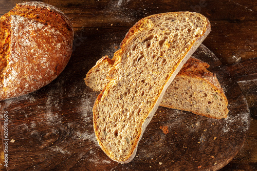 Homemade artisan sourdough bread loaf on a rustic wooden cutting board