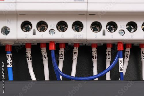 Marking electrical wiring wires with thermally printed nylon tape. 