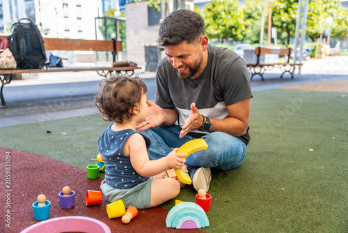 Foto Father and son playing together with wooden toys