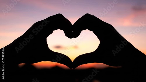 Silhouette Hands Forming Heart Shape at Sunset Sky, Romantic Love Symbol