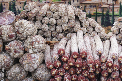 Assortment of artisanal italian salami sausage and cured meat at farmers market in italy