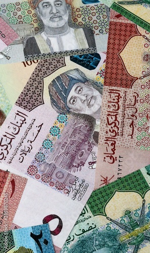 Omani rial money bills in pile on table. Oman OMR currency cash close up