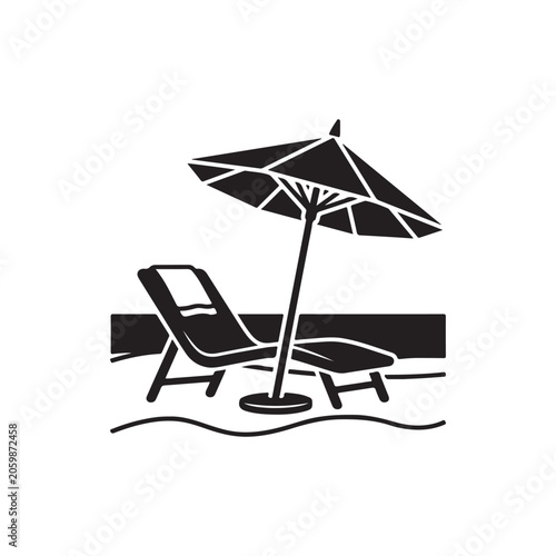 Black and white of a beach lounge chair with a towel and a large sun umbrella on the sandy shore near the ocean waves