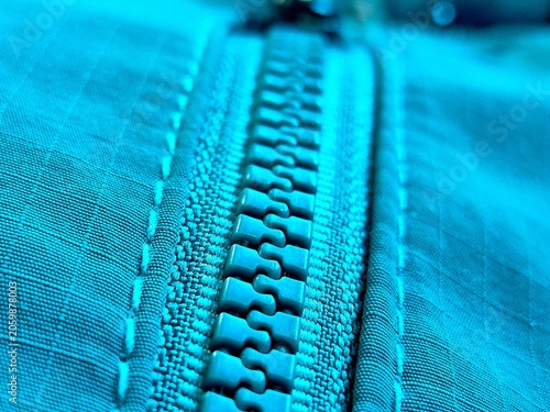 Macro shot of a bright blue plastic zipper