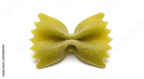 Single piece of green spinach farfalle pasta bow tie with farfalle, ingredient