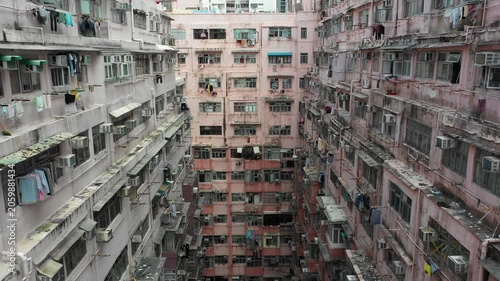 Hong Kong housing crisis - Abstract retreating drone shot through narrow claustrophobic apartment complex in Quarry Bay area