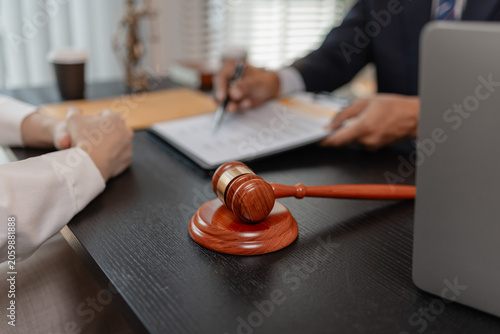 Photos Professional legal consultation meeting between lawyer and client in office, discussing case documents, legal advice, contract review, negotiation, and justice services in a corporate setting