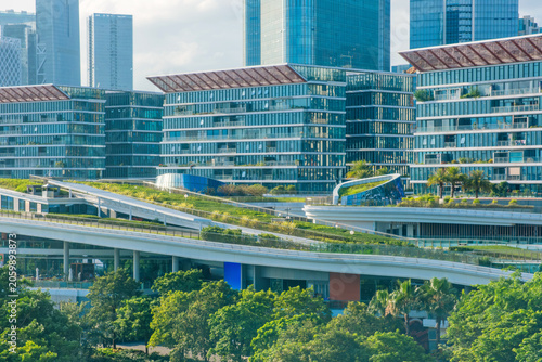 Contemporary mixed-use development with green roofs, landscaped terraces and modern office buildings in Shenzhen city, Guangdong Province, China. Sustainable urban design and eco-friendly architecture