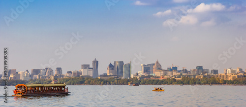 Panorama of a cruise boat and the skyline of Hangzhou, China